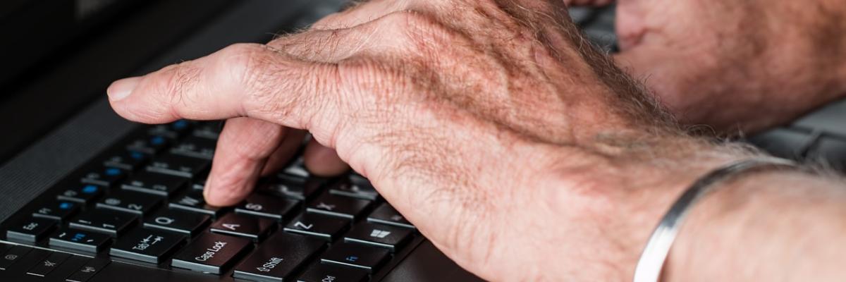 Close-up of person’s hands typing on a laptop 