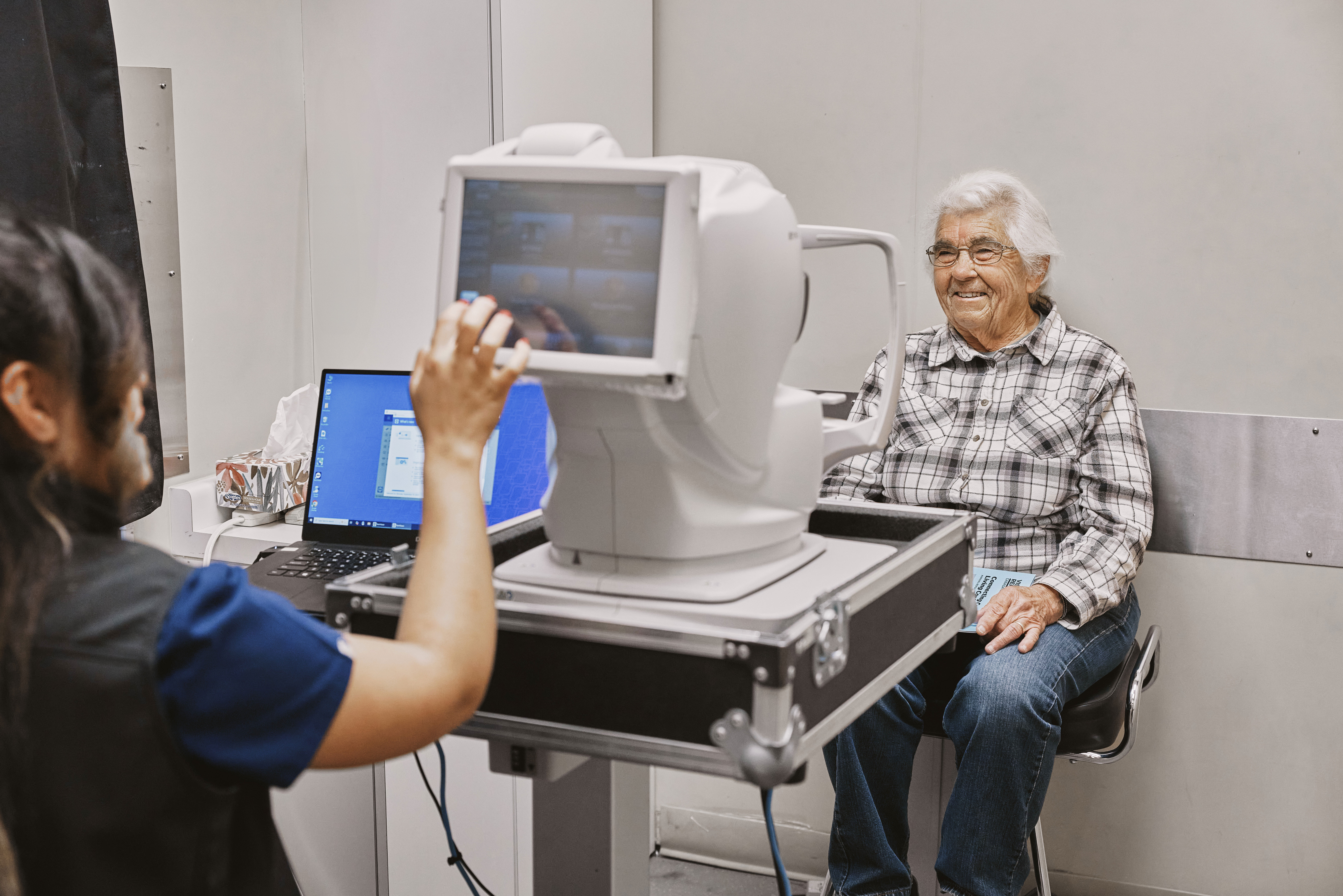 a man smiling as he gets his eyes examined