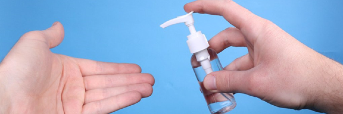 Hands applying hand sanitizer