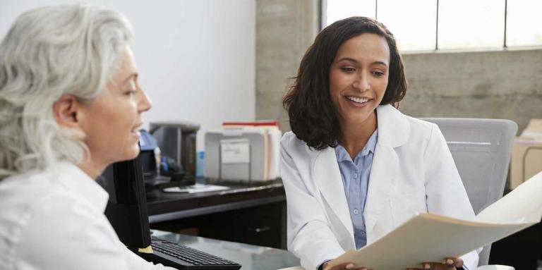 Two professional women smiling and working together