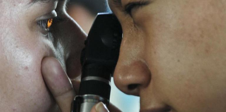 Optometrist checking a child's eye