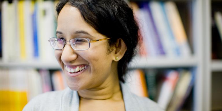 Woman wearing glasses, smiling