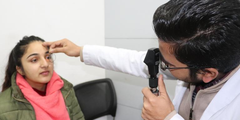 Eye doctor giving patient an eye exam