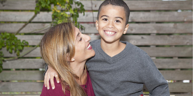 Mother and young boy smiling