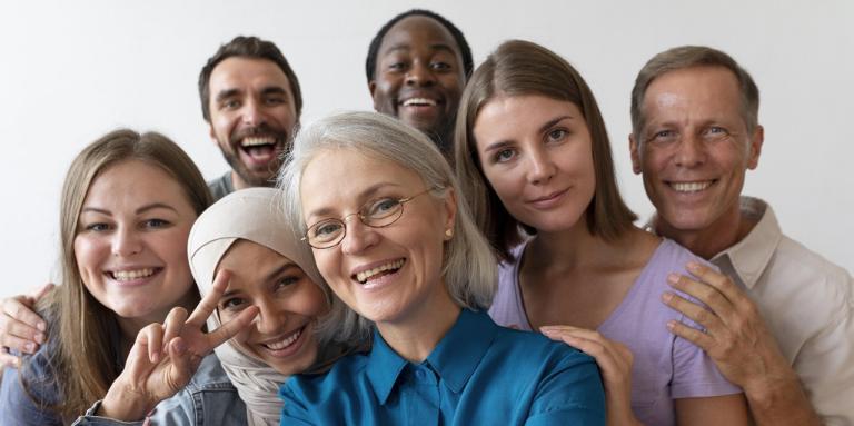 A group of racially diverse people take a selfie together